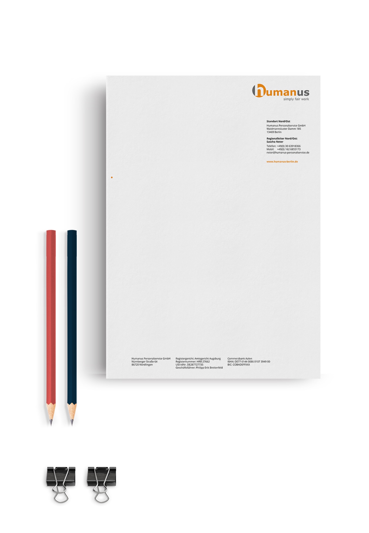 Ein Papierblock mit dem Firmenlogo Humans und 2 Bleistiften auf einer Seite